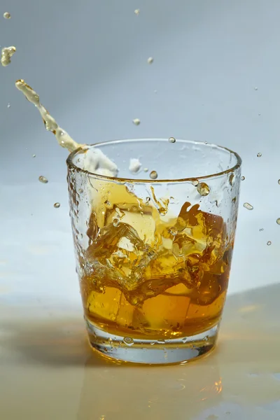 Whiskey with ice on table — Stock Photo, Image
