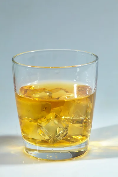 Whiskey with ice on table — Stock Photo, Image