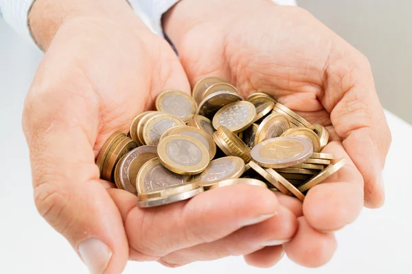 Hands full of  coins — Stock Photo, Image