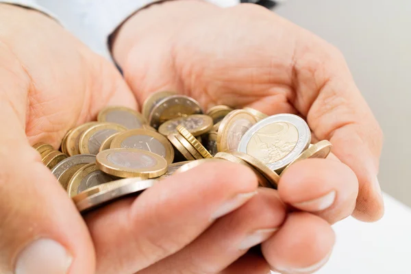 Hands full of  coins — Stock Photo, Image