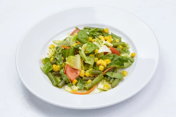 Salad on the white plate — Stock Photo, Image