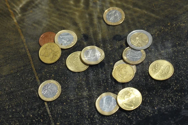 Coins under water — Stock Photo, Image