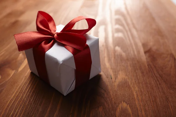 Gift box with red ribbon — Stock Photo, Image