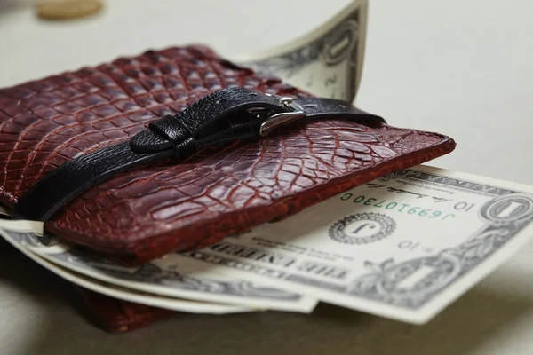 wallet with money wrapped with belt