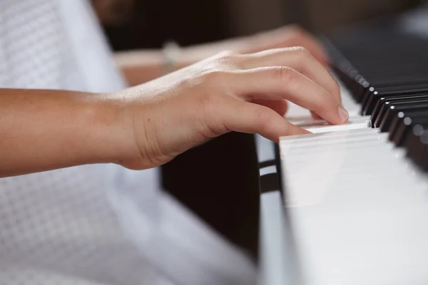 Female's  hands playing piano — Stock Photo, Image