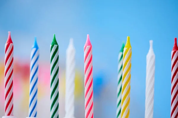 birthday candles on blue background, close view