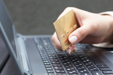 Kredi kartı tutan kadın.