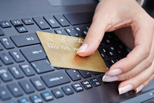 Woman holding credit card on laptop — Stock Photo, Image