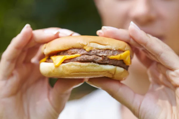 Woman eating hamburger