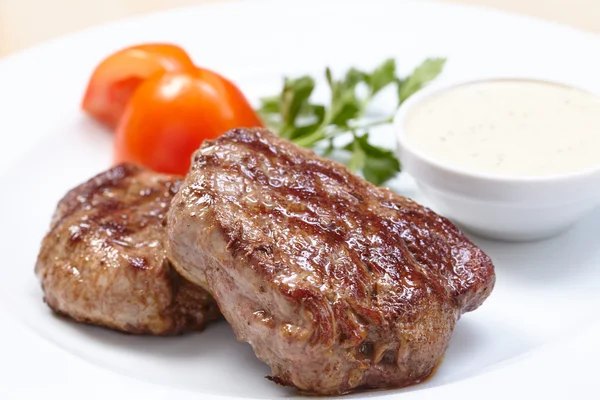 Steak with sauce and tomatoes — Stock Photo, Image