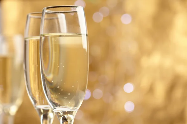 Champagne glasses on gold — Stock Photo, Image