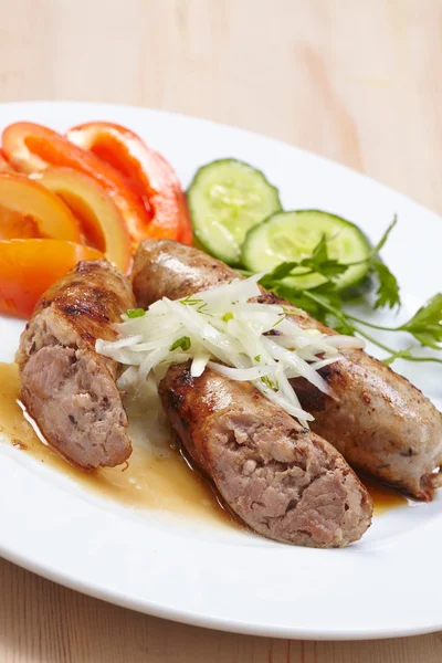 Sausage with vegetables on plate — Stock Photo, Image