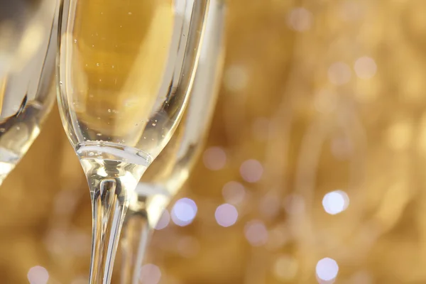 Champagne glasses on gold background — Stock Photo, Image