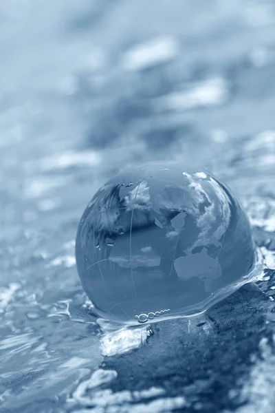 Glass globe on water — Stock Photo, Image