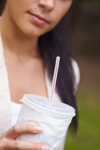 Woman with drink in hands — Stock Photo, Image