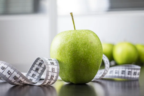 Зеленые яблоки и измерительная лента — стоковое фото