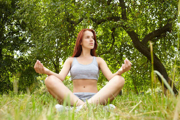 Woman doing yoga exercises in the park