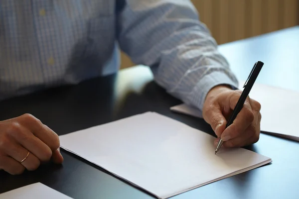 Man with pen in hand Stock Image