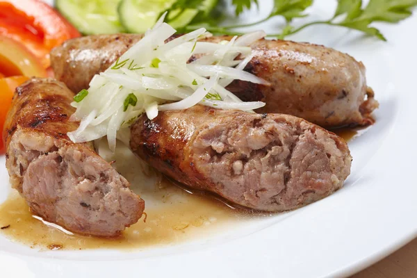 Sausages with vegetables on plate — Stock Photo, Image