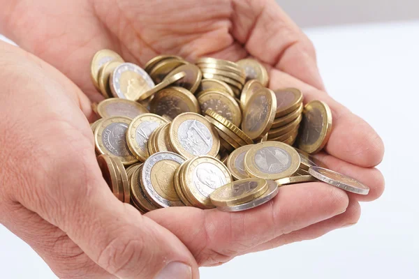 Euro coins in palms — Stock Photo, Image