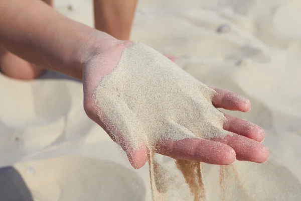 Hand pours sand Stock Photo