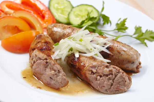 Sausages with vegetables on plate — Stock Photo, Image