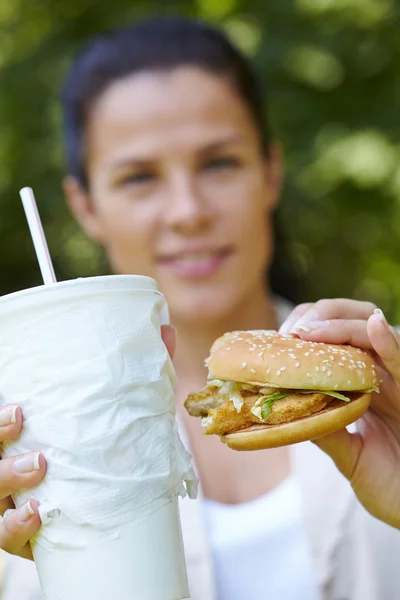 Žena jíst hamburger — Stock fotografie