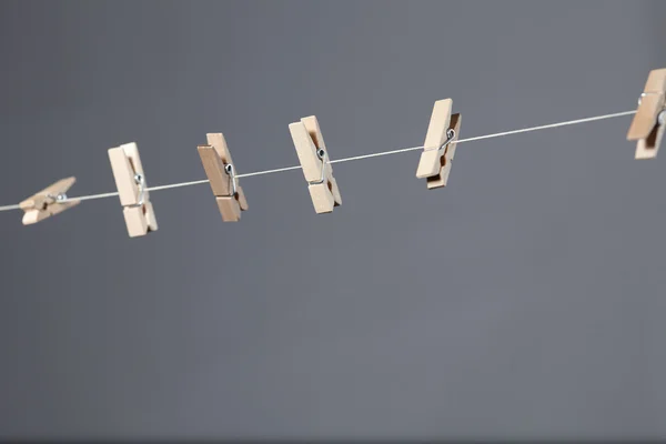 Wooden clothespins on a rope — Stock Photo, Image