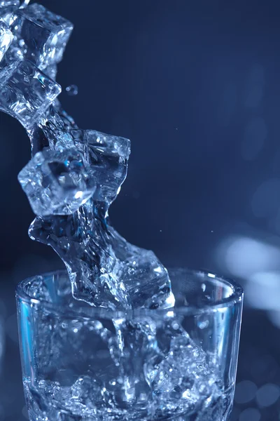 Water in glass on blue — Stock Photo, Image