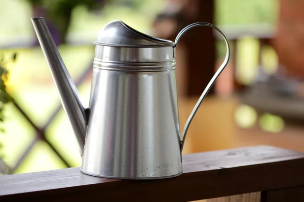 Watering can on  table — Stock Photo, Image