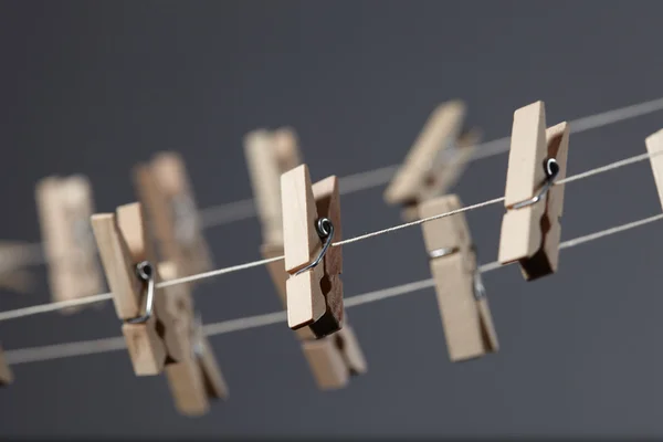 Wooden clothespins on ropes — Stock Photo, Image