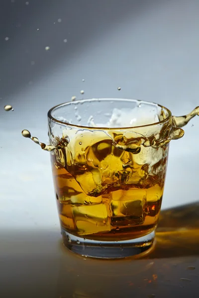 Whiskey with ice cubes in glass — Stock Photo, Image