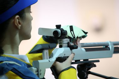 woman aiming a pneumatic air rifle clipart