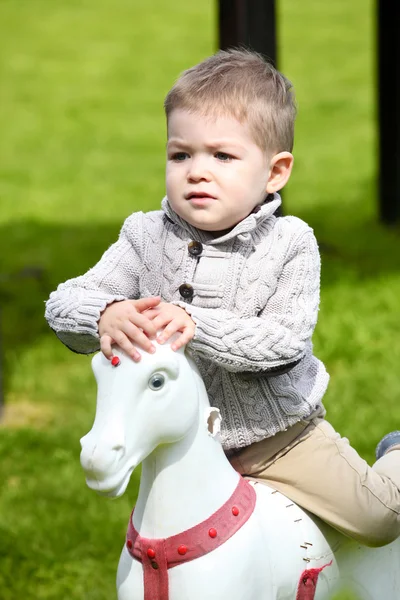 2 years old Baby boy playing with horse — Stock Photo, Image