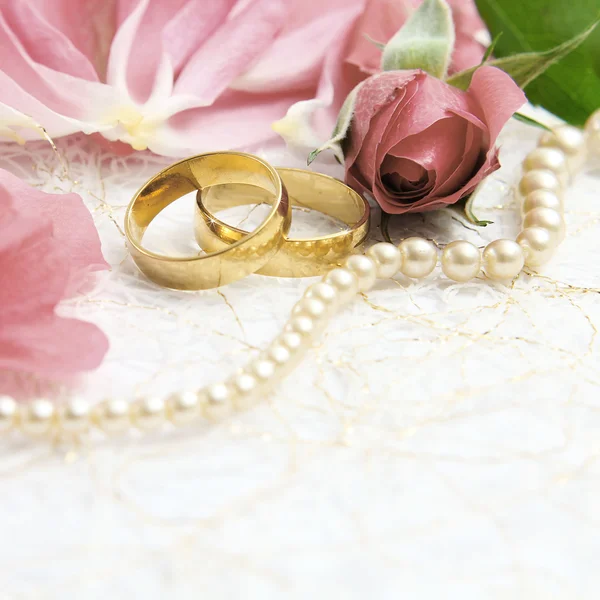 Pair of wedding rings with roses for background image Stock Image