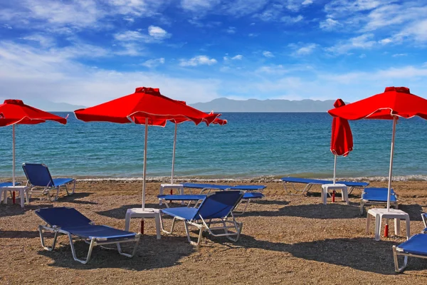 Röd parasollerna på stranden. Grekland, Rhodos — Stockfoto