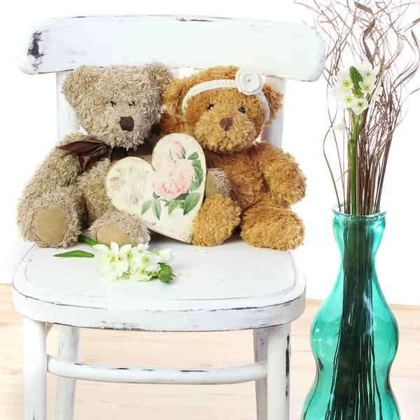 Zwei verliebte Teddybären sitzen auf einem Stuhl. Hochzeitskonzept — Stockfoto