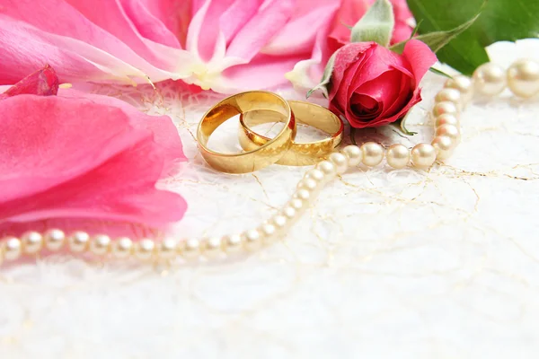 Pair of wedding rings with roses for background image Royalty Free Stock Photos