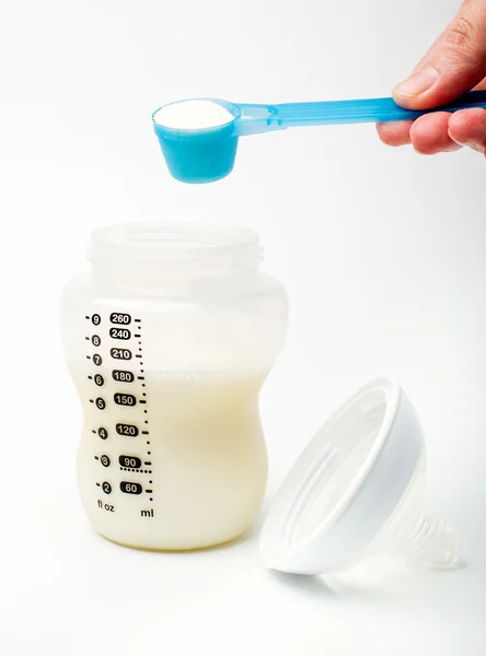 Powdered milk with spoon — Stock Photo, Image