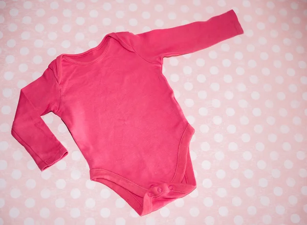 儿童紧身衣与粉红色的背景 — 图库照片