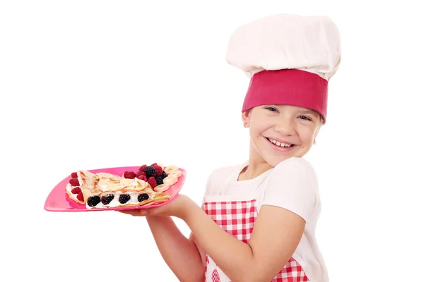 Happy little girl cook with sweet crepes — Stock Photo, Image