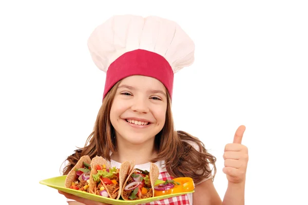 Happy little girl cook with tacos and thumb up — Stock Photo, Image