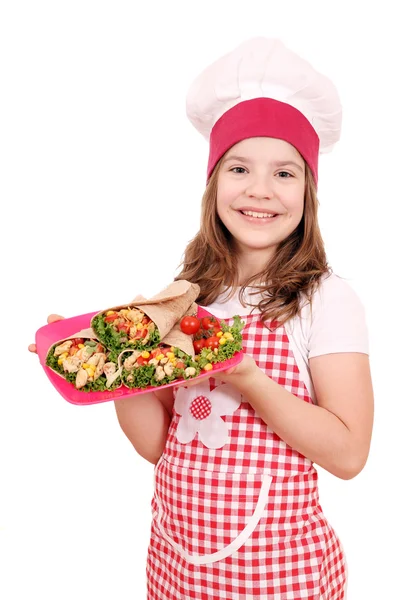 Happy little girl cook with burritos on plate — Stock Photo, Image