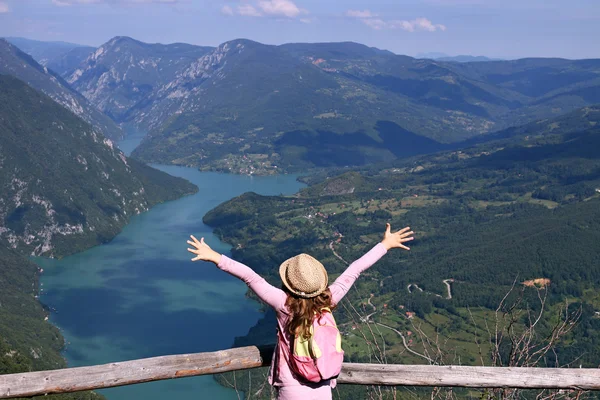 Petite fille randonneur avec les mains vers le haut sur le point de vue montagne — Photo