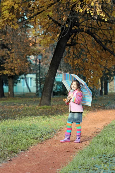 Little girl with umbrella in park autumn season — Stock Photo, Image