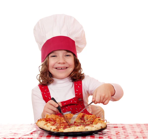 Little girl cook eating pizza — Stock Photo, Image