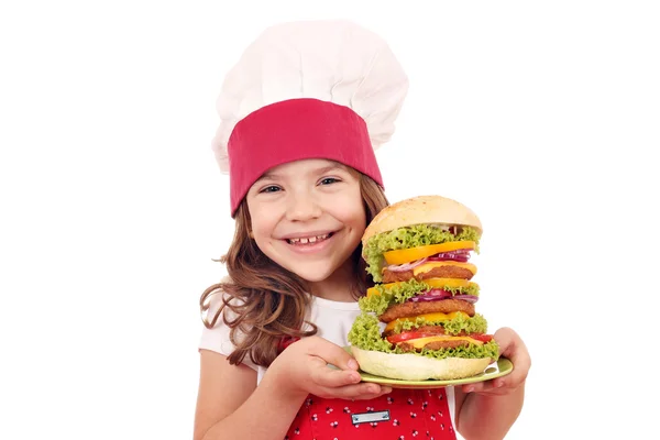 Cocinera de niña feliz con hamburguesa grande — Foto de Stock