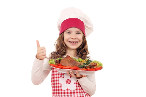 Happy little girl cook with turkey drumstick and thumb up — Stock Photo, Image