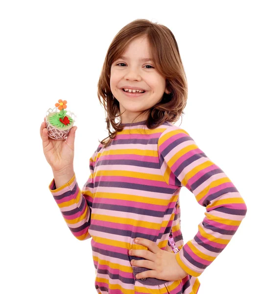 Happy little girl holding spring flower muffin — Stock Photo, Image