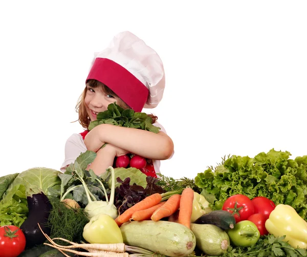 Heureuse petite fille cuisinier avec des légumes — Photo